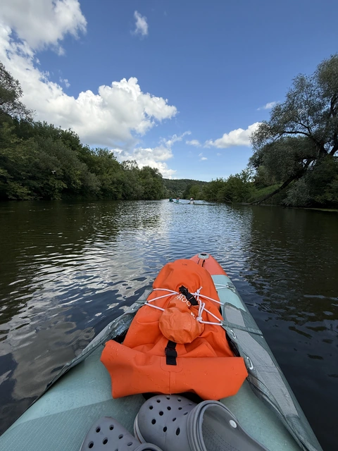Paddling on the river under summer clouds