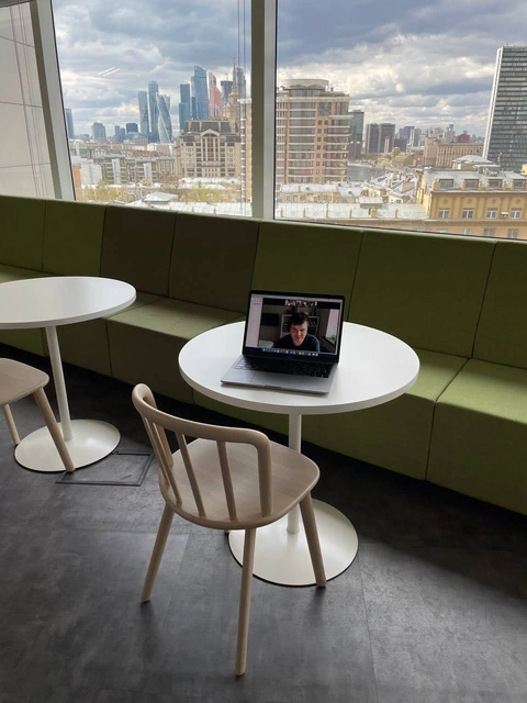 A laptop by the window overlooking the city