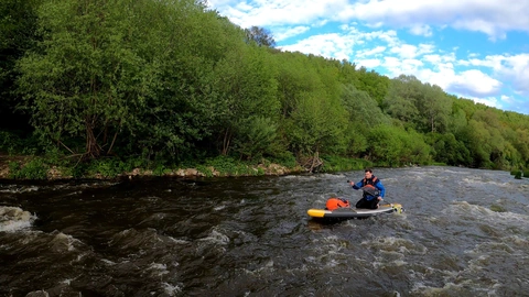 Paddleboarding through river rapids